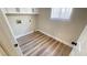 Bright laundry room featuring wood-style floors, storage cabinets, and window at 2851 S Valley View Blvd # 1153, Las Vegas, NV 89102
