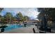 Community pool area surrounded by lush greenery, patio seating, and shade trees at 2851 S Valley View Blvd # 1153, Las Vegas, NV 89102