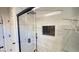Walk-in shower featuring elegant tile and recessed shelf at 2851 S Valley View Blvd # 1153, Las Vegas, NV 89102