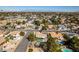 Residential aerial view shows community, pools, landscaping, and mountain views in the distance at 3083 Paintedhills Ave, Las Vegas, NV 89120