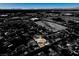 Unique high-angle view highlighting a property with a blue swimming pool contrasted against a monochrome landscape at 3083 Paintedhills Ave, Las Vegas, NV 89120