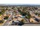 Aerial shot featuring a home with a sparkling pool, lush landscaping, and RV parking in a residential area at 3083 Paintedhills Ave, Las Vegas, NV 89120