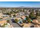 Aerial community view highlighting residential street, landscaping, backyard pools, and mountain views at 3083 Paintedhills Ave, Las Vegas, NV 89120
