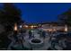 Expansive backyard features a pool, outdoor seating areas, a hammock, and a fire pit for entertaining at 3083 Paintedhills Ave, Las Vegas, NV 89120
