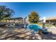 Serene backyard showcasing a pool, covered seating area, mature trees, and well-manicured landscaping at 3083 Paintedhills Ave, Las Vegas, NV 89120