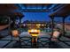 Backyard view showcases a pool, covered patio with dining, and a cozy fire pit for outdoor entertaining at 3083 Paintedhills Ave, Las Vegas, NV 89120