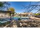Inviting backyard with a sparkling swimming pool, covered pergola, hammock, and well-maintained landscaping at 3083 Paintedhills Ave, Las Vegas, NV 89120