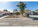 Home featuring xeriscape landscaping, decorative rock, brick walkway and wrought iron gated entry, plus RV parking at 3083 Paintedhills Ave, Las Vegas, NV 89120