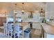 Bright kitchen boasts wood ceiling, island with seating, stainless steel appliances, and stylish countertops at 3083 Paintedhills Ave, Las Vegas, NV 89120