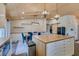 Bright kitchen features modern appliances, butcher block island, wine storage, and a long dining table at 3083 Paintedhills Ave, Las Vegas, NV 89120