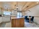 Bright kitchen and dining area featuring a butcher block island, farmhouse sink, and custom lighting fixtures at 3083 Paintedhills Ave, Las Vegas, NV 89120