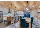 Bright eat-in kitchen features modern appliances, butcher block island, bar seating and a long dining table at 3083 Paintedhills Ave, Las Vegas, NV 89120