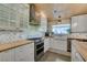 Bright kitchen features modern stainless steel appliances, wood counters, a farmhouse sink, and tiled backsplash at 3083 Paintedhills Ave, Las Vegas, NV 89120