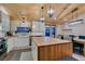Bright kitchen features modern appliances, butcher block island, and eat-in dining space with backyard views at 3083 Paintedhills Ave, Las Vegas, NV 89120
