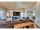 Comfortable living room with hardwood ceiling, entertainment center, fireplace and large sectional at 3083 Paintedhills Ave, Las Vegas, NV 89120