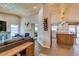 Open-concept living room with fireplace, wood-look floors, and kitchen island at 3083 Paintedhills Ave, Las Vegas, NV 89120