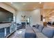 Cozy living room with hardwood floors, wooden ceiling, fireplace, and comfortable gray sectional sofa at 3083 Paintedhills Ave, Las Vegas, NV 89120