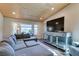 Bright living room featuring an entertainment center, a cozy couch, and hardwood ceiling at 3083 Paintedhills Ave, Las Vegas, NV 89120