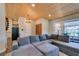 Bright living room featuring an entertainment center, hardwood ceiling and a cozy sectional couch at 3083 Paintedhills Ave, Las Vegas, NV 89120