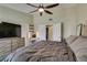 Cozy main bedroom with carpet, ceiling fan, and large dresser with tv at 3083 Paintedhills Ave, Las Vegas, NV 89120
