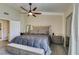 Well-lit primary bedroom featuring carpet, fan, ample space, and neutral walls at 3083 Paintedhills Ave, Las Vegas, NV 89120