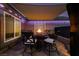 Relaxing patio with a shade and a fire pit table and seating for outdoor enjoyment at 3083 Paintedhills Ave, Las Vegas, NV 89120