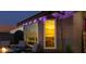 Cozy outdoor patio with fire pit, comfortable seating, and a view through the window into the home at 3083 Paintedhills Ave, Las Vegas, NV 89120