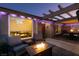 Charming patio with a fire pit, cozy seating, ambient lighting, and an inviting red door at 3083 Paintedhills Ave, Las Vegas, NV 89120