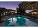 Backyard pool area showcasing inviting pool with umbrellas, pergola, and a tranquil evening atmosphere at 3083 Paintedhills Ave, Las Vegas, NV 89120