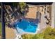 Aerial view of backyard swimming pool area with outdoor seating, fire pit, and lush landscaping at 3083 Paintedhills Ave, Las Vegas, NV 89120