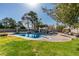 Landscaped backyard features a swimming pool, diving board, grassy lawn, and covered patio at 3083 Paintedhills Ave, Las Vegas, NV 89120