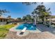 Backyard pool with diving board, covered patio, brickwork, privacy fence, and desert landscaping at 3083 Paintedhills Ave, Las Vegas, NV 89120