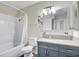 Well-lit bathroom with a tub, shower, modern vanity and stylish decorative floral accents at 3247 Greenbriar Dr, Las Vegas, NV 89121