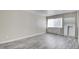 Bright bedroom with light gray floors, neutral walls, closet space, and a large window with natural light at 3247 Greenbriar Dr, Las Vegas, NV 89121