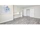 Bedroom featuring gray wood floors, neutral colored walls, closet space and built-in white shelving at 3247 Greenbriar Dr, Las Vegas, NV 89121