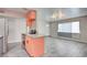 Modern kitchen featuring stainless steel appliances, light grey countertops, and trendy peach colored cabinetry at 3247 Greenbriar Dr, Las Vegas, NV 89121