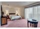 Spacious bedroom featuring plush carpeting, a sliding glass door, and dark furniture at 3301 China Dr, Las Vegas, NV 89121