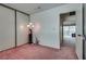 Bedroom with neutral walls, carpet, closet with sliding doors, and view to other rooms at 3301 China Dr, Las Vegas, NV 89121