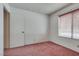 Bedroom featuring neutral walls, carpet, closet, and a window at 3301 China Dr, Las Vegas, NV 89121