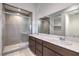 Modern bathroom featuring dual sinks, a spacious shower with glass enclosure, and stylish tile work at 3346 Esker Ridge Ave, Henderson, NV 89044