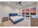 Comfortable bedroom with a blue upholstered bed, desert views, and carpet at 3346 Esker Ridge Ave, Henderson, NV 89044