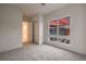 Spacious bedroom with large window view of nearby buildings, carpet, and closet at 3346 Esker Ridge Ave, Henderson, NV 89044