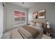 Comfortable bedroom featuring a plush bed, soft lighting, and a window with a vibrant sunset view at 3346 Esker Ridge Ave, Henderson, NV 89044