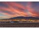 Spectacular sunset view over the city skyline and mountains, showcasing the vibrant lights and natural beauty at 3346 Esker Ridge Ave, Henderson, NV 89044