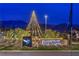 A well-lit community entrance sign decorated with festive holiday lights at 3346 Esker Ridge Ave, Henderson, NV 89044