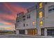Modern townhome exterior showcasing clean lines, a rooftop terrace, and a two-car garage at 3346 Esker Ridge Ave, Henderson, NV 89044