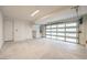 Clean garage with frosted glass garage door, side door, and concrete flooring at 3346 Esker Ridge Ave, Henderson, NV 89044