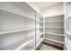 Spacious walk-in pantry with ample shelving for storage and a window for natural light at 3346 Esker Ridge Ave, Henderson, NV 89044