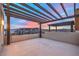 Spacious outdoor patio features a pergola overlooking city and mountain views at sunset at 3346 Esker Ridge Ave, Henderson, NV 89044