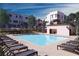 Community pool with lounge chairs and a nearby outdoor kitchen and recreation area at 3346 Esker Ridge Ave, Henderson, NV 89044